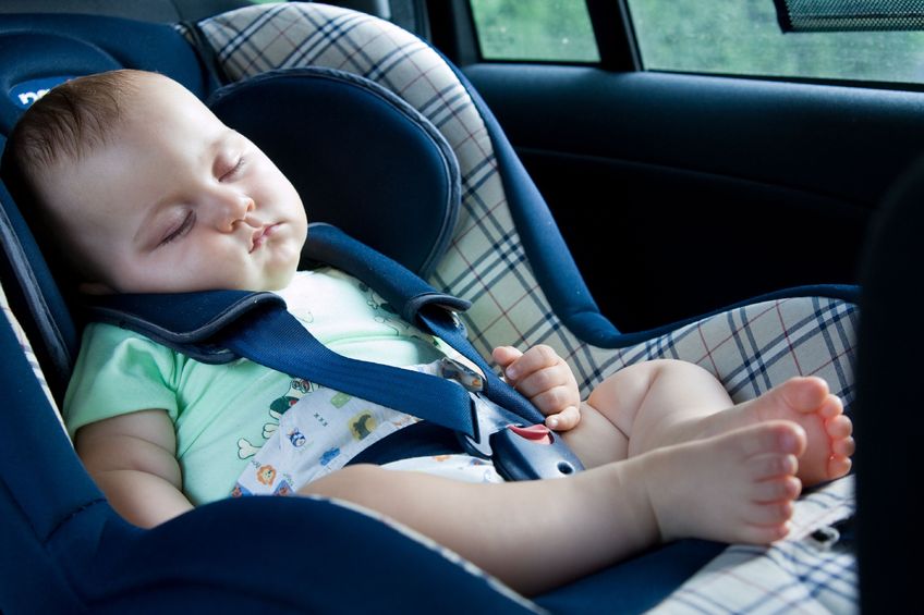 little baby sitting in safety car seat