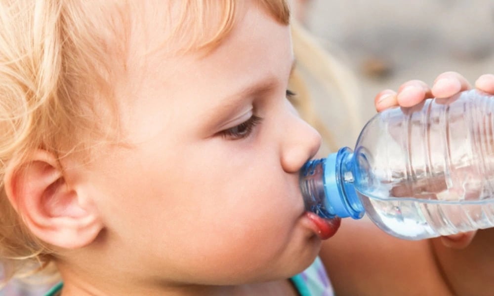 baby drinking water from water bottle